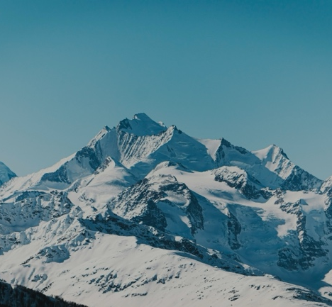 A snowy mountain with blue sky