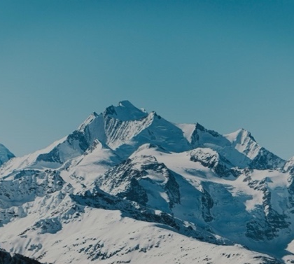 A snowy mountain with blue sky