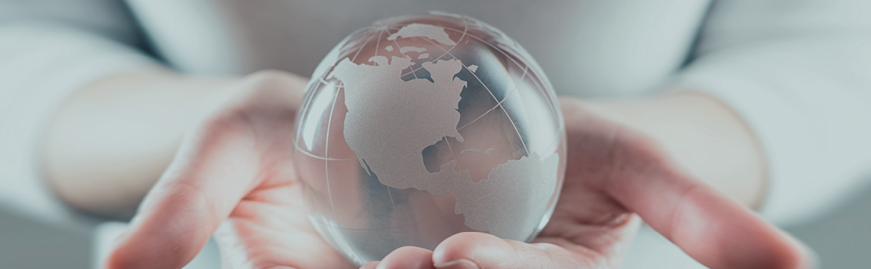 A person holding a glass globe