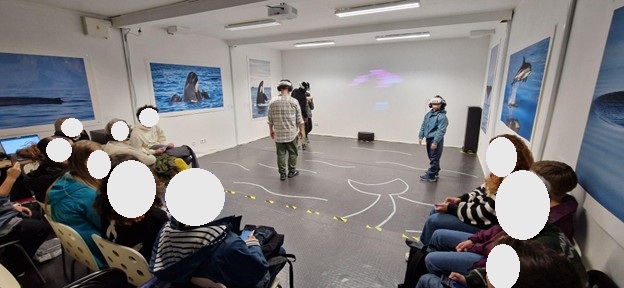 photo of participants using virtual reality and some audience