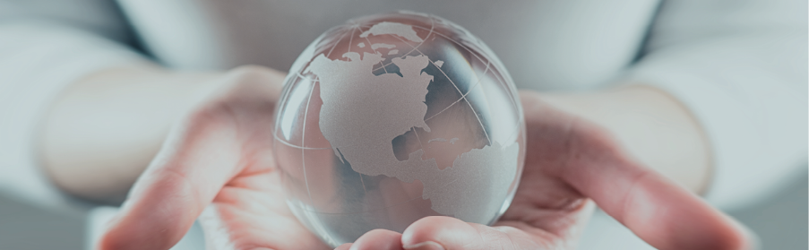 A person holding a glass globe
